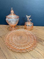 All three pink Depression glass pieces grouped together