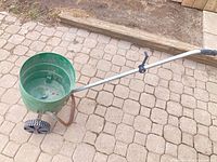 Full view of spreader showing hopper, wheels and handle