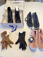 Group shot of boots, two pairs of sneakers, and gloves