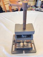 Front view of cast iron arbor press showing T-handle, screw, ram and slotted base