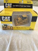 Front view of CAT D6R XL 1:64 scale die-cast tractor in box