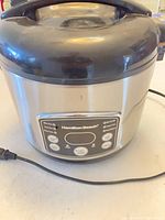 Front view Hamilton Beach stainless rice cooker showing control panel and attached power cord