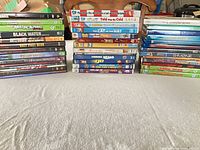 Wide shot of three stacks of disc cases on table showing quantity