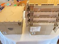 Five tan Matrix plastic storage boxes stacked beside one upright to show sides and branding