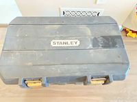 Closed Stanley toolbox top view showing brand badge and wear