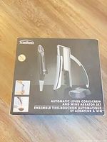 Retail box showing Trudeau automatic lever corkscrew, wine aerator and stand