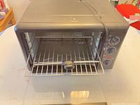 Front view of toaster oven with door open showing included rack