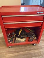 Front view of Waterloo red tool chest with lower shelf contents visible