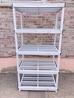 Full front view showing five plastic shelves