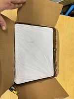 Box opened showing shrink-wrapped stack of label sheets