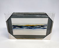 Front view of shrink-wrapped framed abstract print