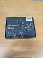 closed retail box front displaying Aquadalus handheld bidet sprayer graphics