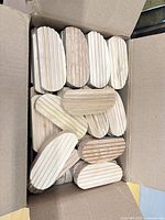 Open box showing quantity and form of grooved wood blocks