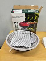 Unassembled grill parts and grate with box