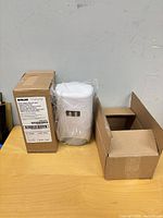 Boxed Ecolab dispenser beside opened box and sealed dispenser