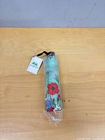 Umbrella in sealed plastic with tag visible