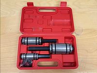 Open case showing three exhaust pipe expanders and accessories