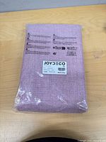 Front view of packaged Joydeco curtain set