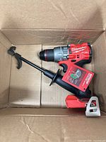 Drill/driver body with side handle inside cardboard box