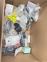 Top view showing majority of sealed accessories including digital scale, braided cable, clear clips, small boxes