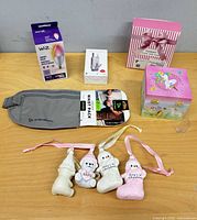 All items displayed: waist pack, WiZ bulb box, USB charger box, gift box, four baby ornaments