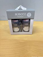 Front view of boxed Robeez First Kicks baby sneakers