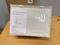 Sealed plastic shoe organizer with instruction sheet visible