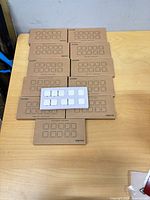 Eleven Smofish boxes arranged on table with one sample clip strip on top