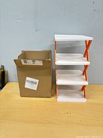 Assembled shelf beside box containing second unit