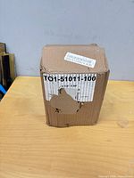Sealed cardboard box showing product label for thermal rolls