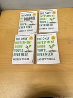 Four identical books laid out on table