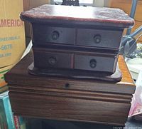 Stacked view of small drawer chest atop larger lockable jewelry box