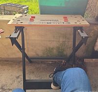 Front view showing full workbench, wooden top, steel legs