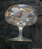 Side view of compote showing stem, bowl shape, etched motif