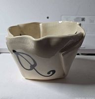 angled side view showing crackle glaze and painted motif