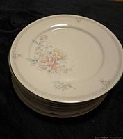 Stack of Noritake Easthampton plates showing floral design and border