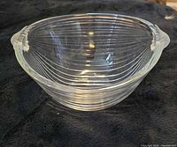 Side view of clear ribbed bowl with frosted handles
