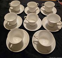 Set of teacups and saucers arranged
