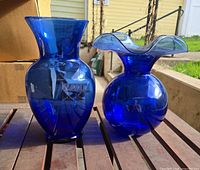 Both cobalt blue vases side by side on table