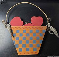 Front of basket-shaped wooden plaque with hearts and handle