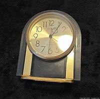 Front view showing clock face and acrylic body