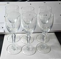 Group shot of six clear cordial glasses standing upright