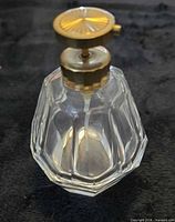 Front view showing faceted glass body and brass pump
