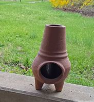 Full view of terracotta chiminea outdoors