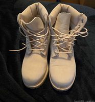 Front view of both boots showing laces, toe shape and leather condition