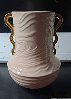 Full side view showing pink textured body and gold handles