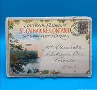 Front cover of souvenir folder showing title and address