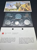 Front view of set with insert card above and pliofilm-sealed coins below
