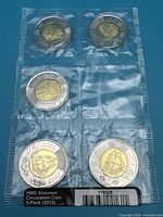 Front of sealed strip showing three coins reverse side with HMS Shannon design