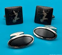 Both pairs of cufflinks front view on blue background